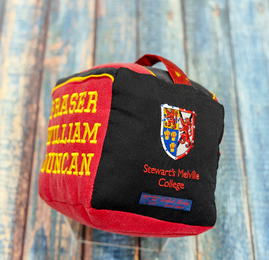 Fabric doorstop made from scraps of Stew Mel school uniform. Can be personalised with any details, an ideal gift for teenagers